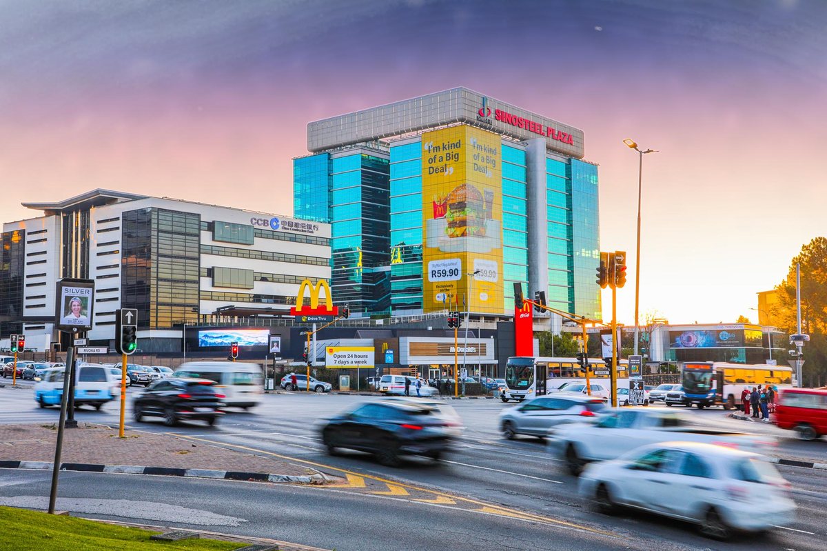 McDonald's building wrap towering over Rivonia Road traffic in Sandton